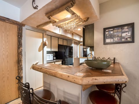 View of bar and kitchen. Bar seats up to 4 people.