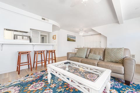 Main living spaces looking toward front entry. Open floor plan between living, kitchen and dining areas.