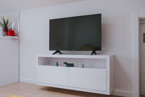 Deluxe Apartment, 1 Bedroom | Living area | 55-inch flat-screen TV with satellite channels, TV