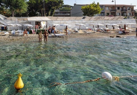 On the beach, sun loungers, beach umbrellas