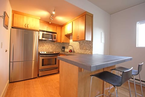 Spacious kitchen with eating bar.

