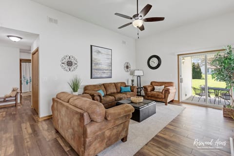 Spacious living room with open floor plan with 55" smart tv over the fireplace
