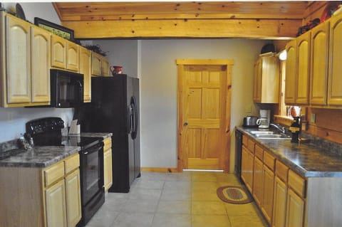 Kitchen area with laundry room through the door.