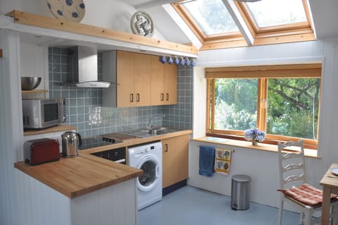 The kitchen is well equipped and looks out on the garden