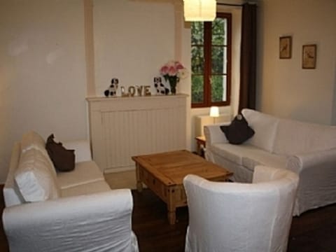 Living Room - open fireplace & doors to garden