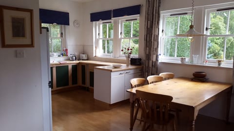 Spacious kitchen with large dining table.
