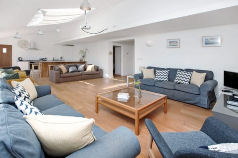 large lower ground floor cinema lounge showing bar and kitchen in distance