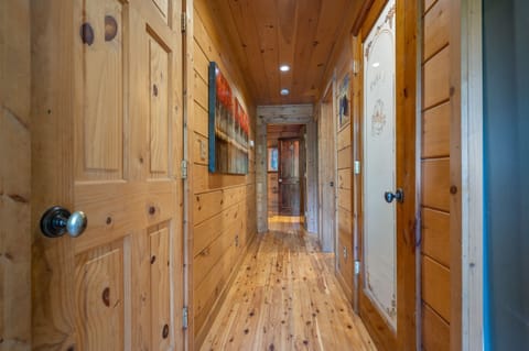 Hallway to main floor bedroom with laundry room and pantry.