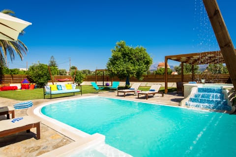 Lawn covered private garden equipped with playground and hammock.