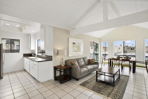 Gather together in the open concept living and dining area with glass doors leading to the front deck