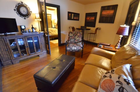 Living area includes leather sleeper sofa, mini fridge, DVD player and Wi-Fi