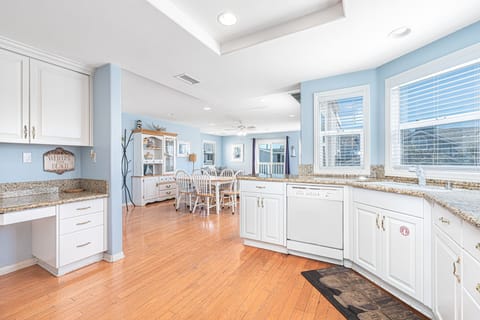 Kitchen includes built-in desk area and opens up to the main living area for fun, social meals.