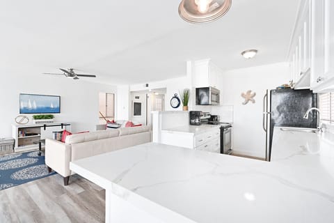 The kitchen counter includes barstool seating, making meal prep a social affair!