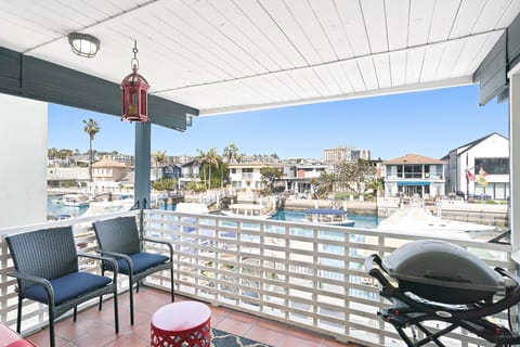 The outdoor deck offers shade and views, seating and a grill, for evening cookouts after a day at the beach.