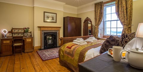 Bedroom 1 with kingsize bed, fireplace and valley views