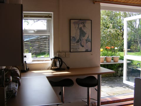 Fully equipped kitchen with French doors opening onto patio/garden and decking 