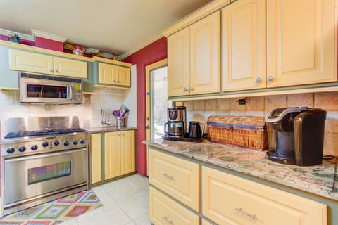 Beautiful granite counter tops throughout kitchen, two coffee makers.