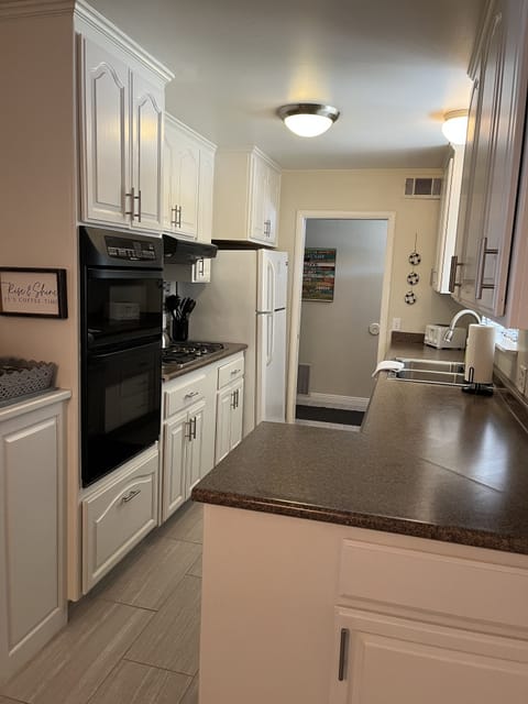 Galley kitchen flows to homes entry and dining table and family room...