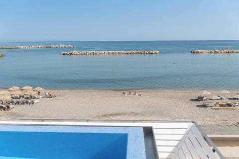 Rooftop pool, beach below.