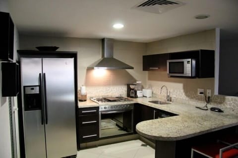 Spacious kitchen has modern stainless appliances and granite tops