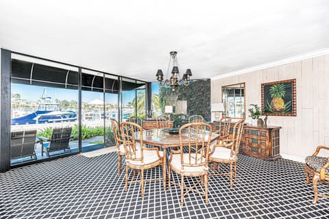 The dining area includes seating for 8, floor-to-ceiling windows, side board buffet, tea cart, and pass-thru granite counter to kitchen for easy, comfortable hosting.