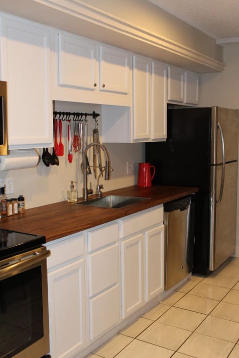 Kitchen has updated countertop with new sink and faucet