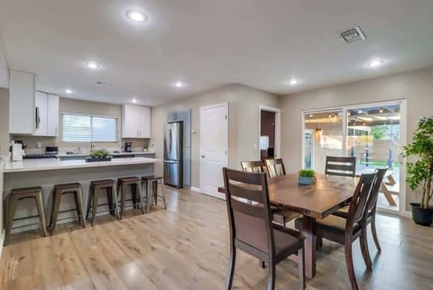 A dining table and breakfast bar provide plenty of seating to enjoy a meal