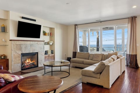 Perfect gathering area for friends and family in front of fire with ocean view.