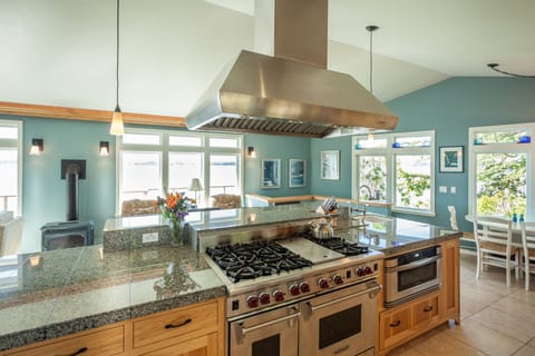 The kitchen offers all desired cookware, double oven, and gourmet gas range.