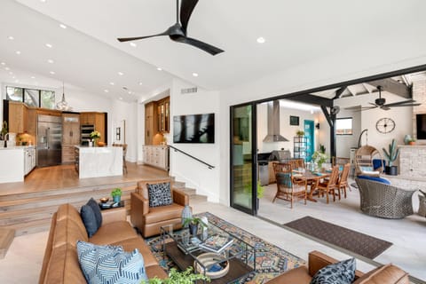 The living area with plush leather couch and a sizable TV