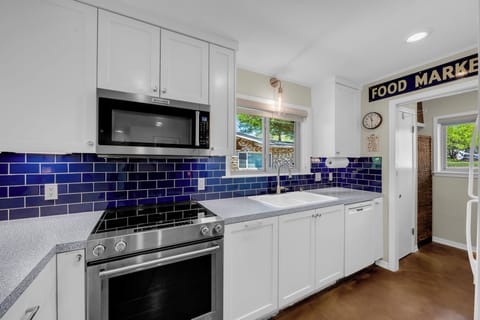 Fully equipped kitchen has everything for the chef and a convenient laundry room