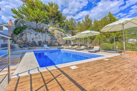 Pool area with loungers and parasols