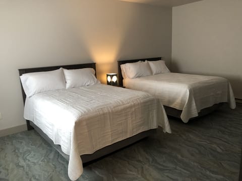 Deluxe Quadruple Room, 2 Queen Beds, Non Smoking | In-room safe, blackout drapes, iron/ironing board, free WiFi