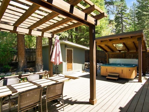 Enjoy the privacy of a fully fenced backyard, featuring a spacious deck with a hot tub, plus a table and chairs perfect for outdoor dining and relaxation