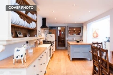 Large kitchen with doors out to lovely walled garden