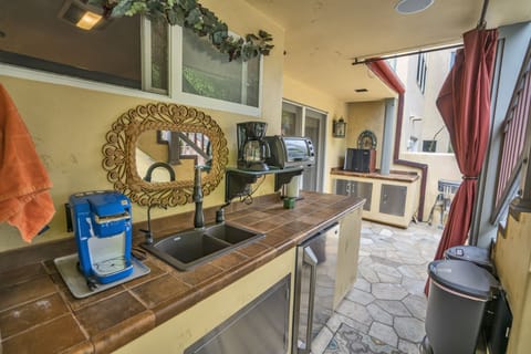 Refrigerator is to the right of sink. Large freezer is separate. Many appliances