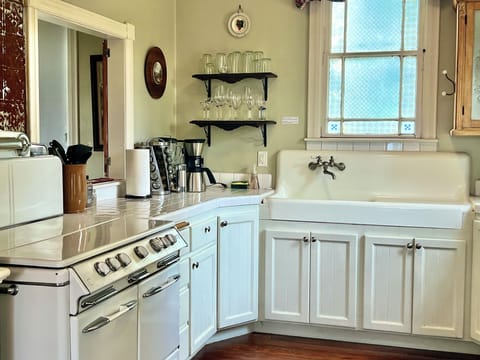 Kitchen w antique farm sink and everything you need to prepare and serve  meals