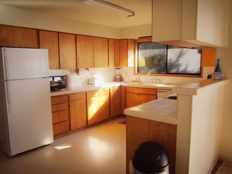 Well stocked, Spacious Kitchen with lots of room to prepare meals. 