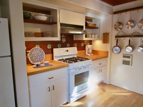 A well-equipped kitchen, with blender, mixer, convection oven and dishwasher .