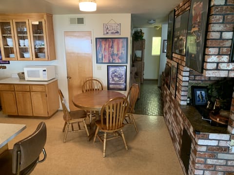 Part of the kitchen to front door. High stools up to the bar & dining table.