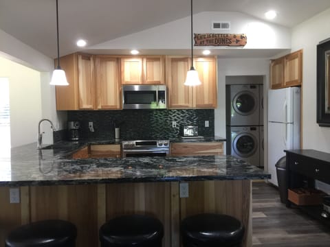 Custom built cabinets, granite counter top and 8 stools.