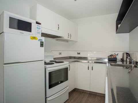 Two Bedroom Apartment | Private kitchen | Full-size fridge, microwave, oven, stovetop