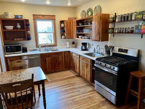 Fully equipped kitchen with modern gas stove and dishwasher.