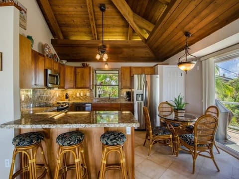 Upstairs kitchen with stainless steel appliances and granite counters