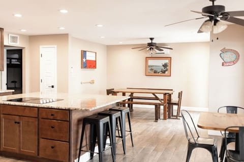 Open kitchen with large island, farm table, and dining nook