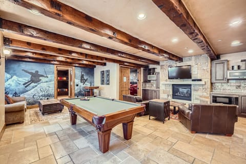 Spacious billiard room with a pool table and cozy seating, perfect for evening entertainment and friendly competition.