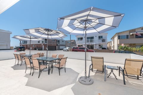 This home's oversized patio includes lounge chairs, two market umbrellas, and outdoor tables and chairs. Group hangouts don't get easier than this!
                