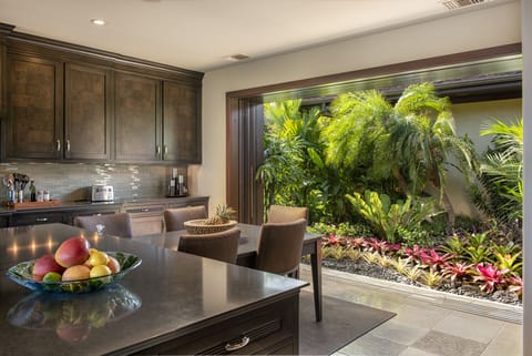 CHEF'S TABLE SEATING FOR FIVE IS SURROUNDED BY A BEAUTIFUL TROPICAL GARDEN