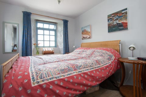 Double bedroom with sunshine pouring in and distant sea views