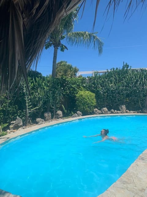 Swim in the tropical garden pool.